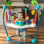 Baby Einstein Neighborhood Symphony Activity Centro de Actividades Saltador para Bebés, Entretenedor Infantil con Luces