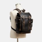 COACH Mochila de enganche en cuero querido