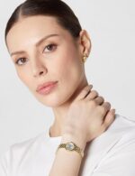 Reloj de vestir Tissot T-Trend T0580093303100 mujer acero inoxidable oro amarillo esfera plateada movimiento de cuarzo s